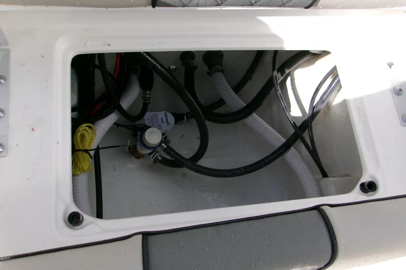 Slide: The Image of Open compartment of 2026 Key West 179 FS boat showing internal wiring and components. - 15