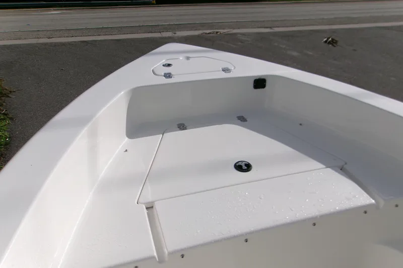 Slide: The Image of 2026 Key West 179 FS boat deck, featuring sleek white design and storage compartments. - 7