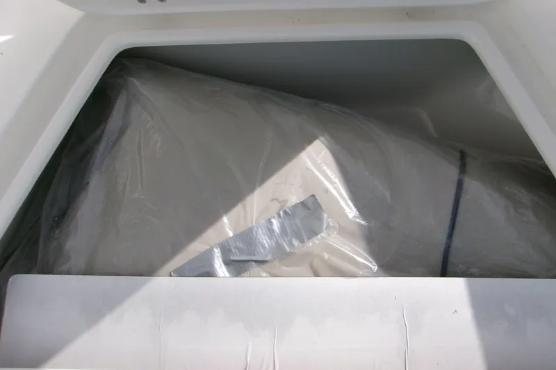 Slide: The Image of Storage compartment of 2026 Key West 179 FS boat, containing wrapped items. - 9