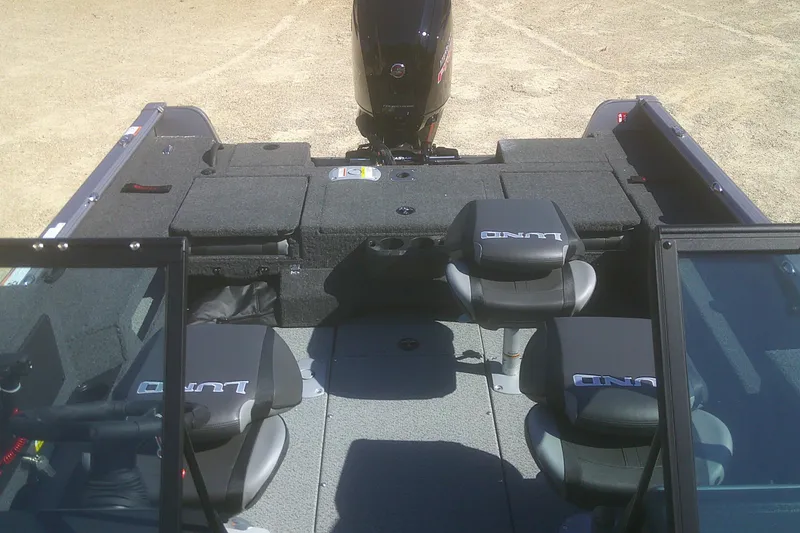 Slide: The Image of 2026 Lund 1775 Impact XS Sport boat interior with seating and motor. - 10