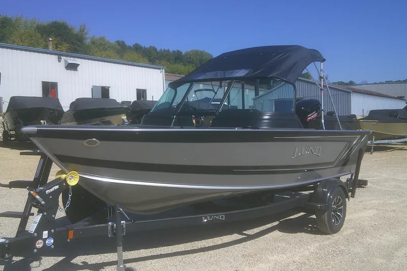 Slide: The Image of 2026 Lund 1775 Impact XS Sport boat on trailer, parked outdoors. - 4