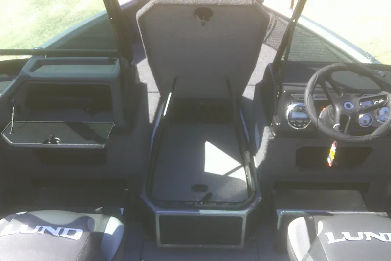 Slide: The Image of 2026 Lund 1775 Impact XS Sport boat interior with steering wheel and seating. - 7