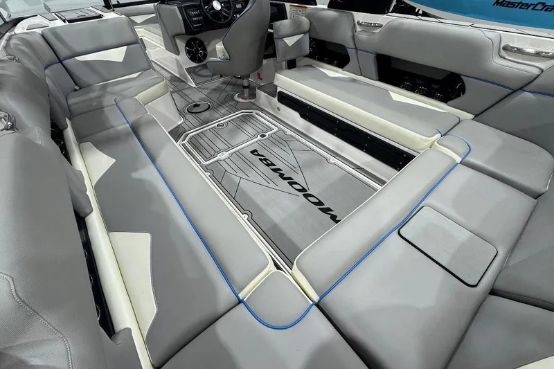 Slide: The Image of 2020 Moomba Makai boat interior with gray seating and modern dashboard design. - 11