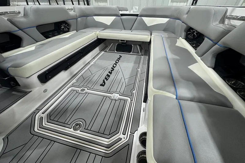 Slide: The Image of 2020 Moomba Makai boat interior with gray seating and custom flooring. - 12