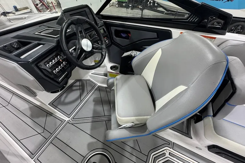 Slide: The Image of 2020 Moomba Makai boat interior with steering wheel and gray captain's seat. - 13