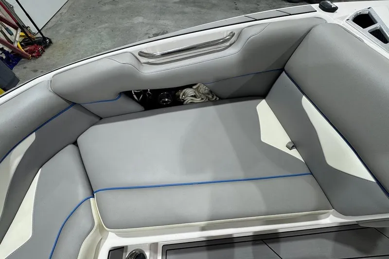 Slide: The Image of 2020 Moomba Makai boat interior with gray seating and blue accents. - 17