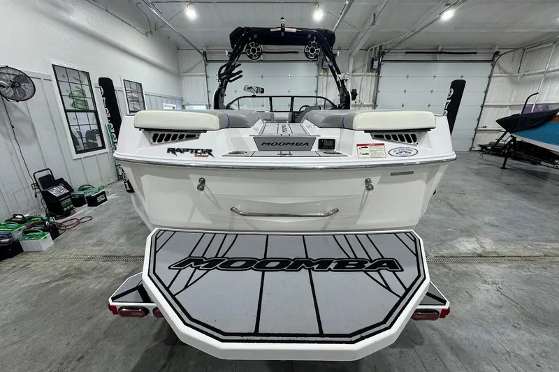 Slide: The Image of 2020 Moomba Makai boat in a garage, showcasing rear deck and interior features. - 3