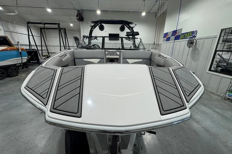 Slide: The Image of 2020 Moomba Makai boat interior in showroom, featuring sleek seating and modern design. - 8