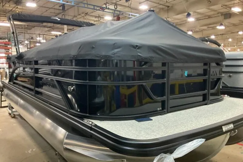 Slide: The Image of 2026 Bennington 22 SSRSE pontoon boat with cover in a warehouse setting. - 11
