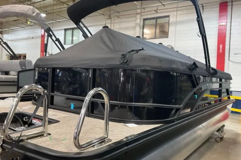 Slide: The Image of 2026 Bennington 22 SSRSE pontoon boat with cover in a showroom. - 14