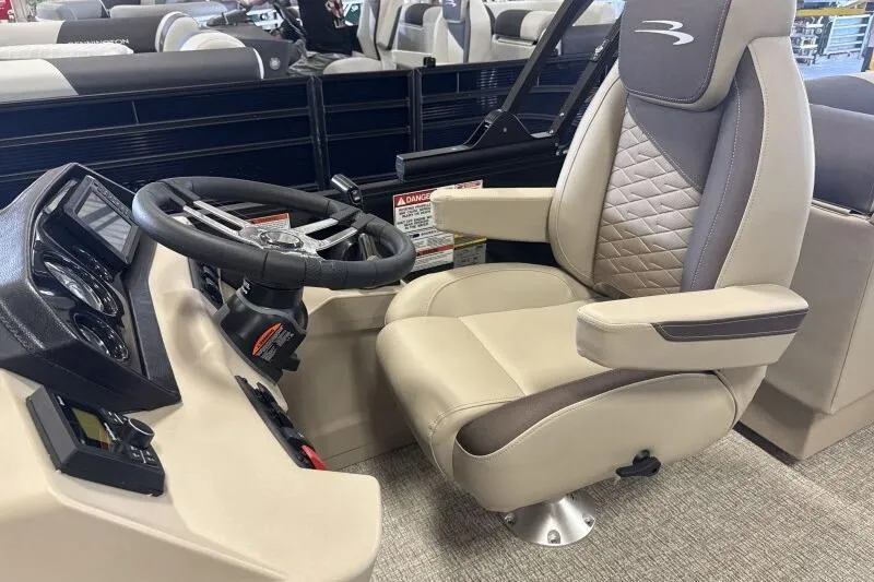Slide: The Image of Captain's chair and helm of 2026 Bennington 22 SSRSE pontoon boat, featuring modern controls. - 23