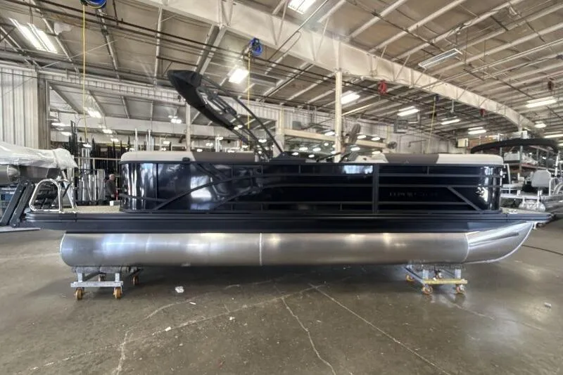 Slide: The Image of 2026 Bennington 22 SSRSE pontoon boat in a warehouse setting. - 6