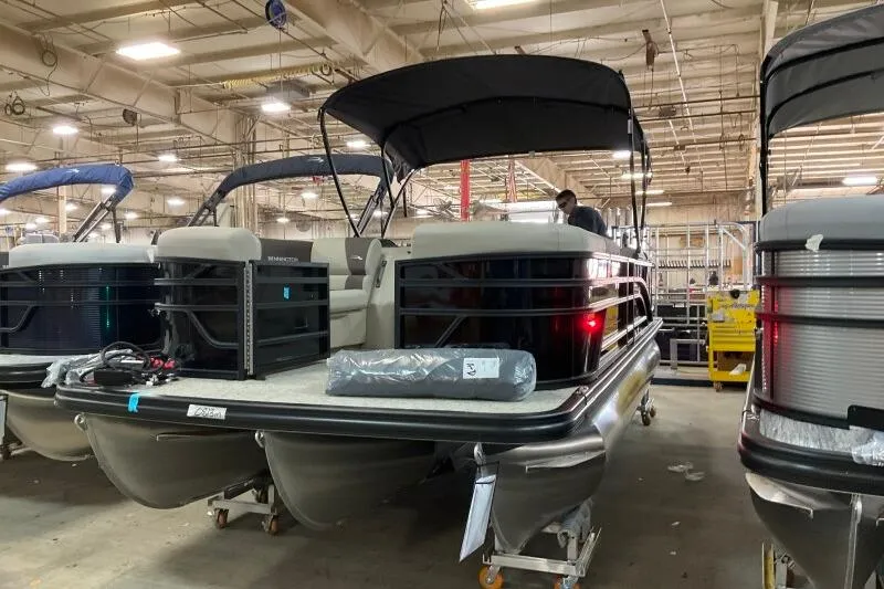 Slide: The Image of 2026 Bennington 22 SSRSE pontoon boat in a factory setting. - 9