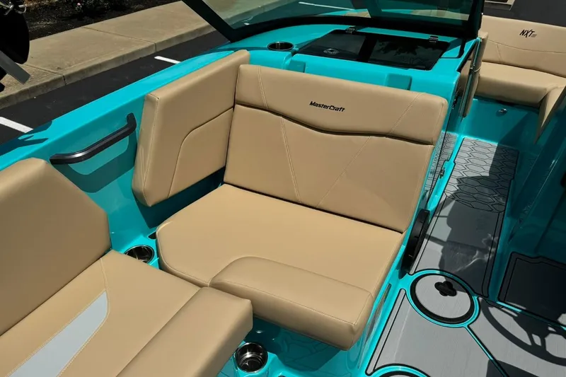 Slide: The Image of 2025 MasterCraft NXT20 boat interior with beige seating and turquoise accents. - 10