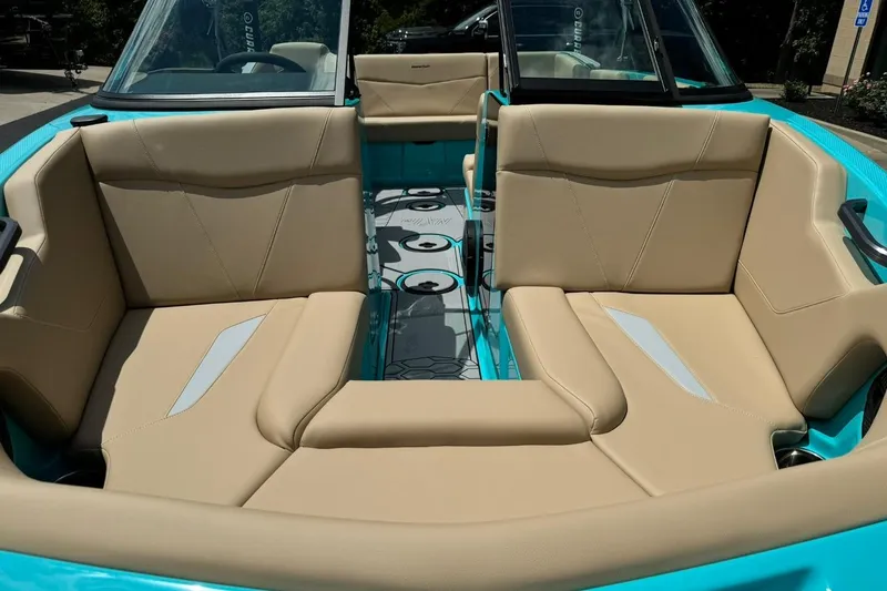Slide: The Image of 2025 MasterCraft NXT20 boat interior with beige seating and turquoise accents. - 7
