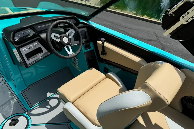 Slide: The Image of Interior of 2025 MasterCraft NXT20 boat with modern dashboard and beige seating. - 9