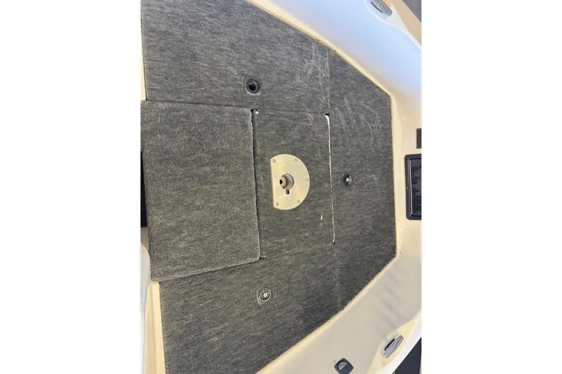 Slide: The Image of 1998 Skeeter WX1850 boat deck with gray carpet and mounting hardware. - 14