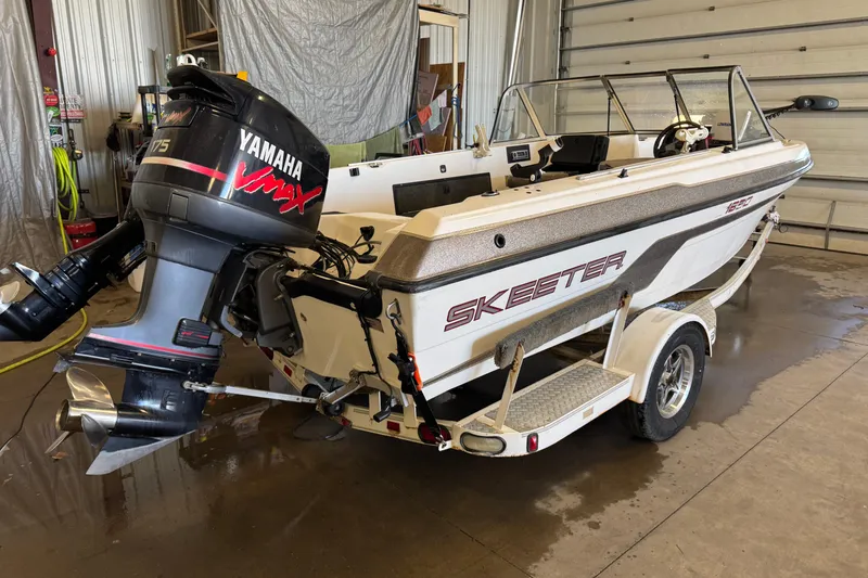 Slide: The Image of 1998 Skeeter WX1850 boat with Yamaha VMAX engine in a garage setting. - 3