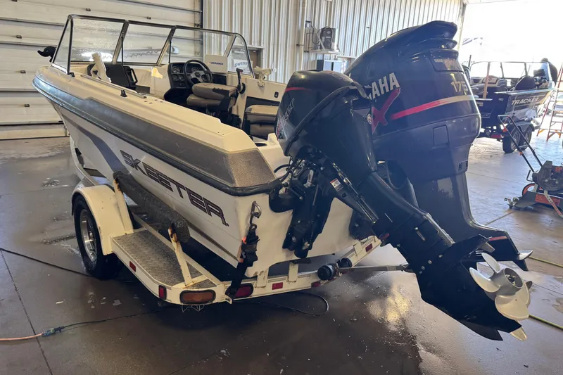 Slide: The Image of 1998 Skeeter WX1850 boat with Yamaha outboard motor in a garage setting. - 4