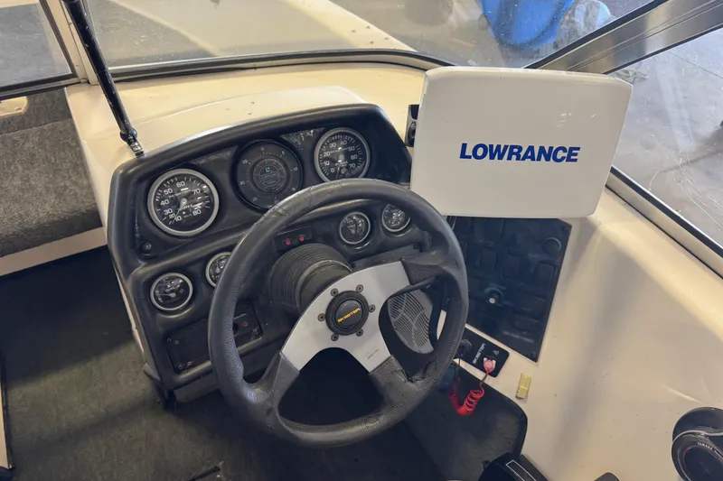 Slide: The Image of 1998 Skeeter WX1850 boat dashboard with steering wheel and Lowrance navigation system. - 8