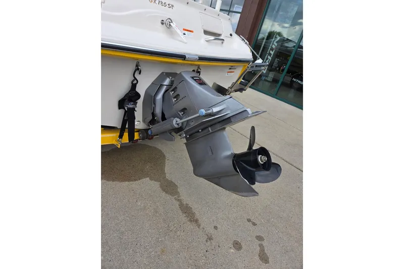 Slide: The Image of 2003 Glastron GX185SF boat with outboard motor on concrete surface. - 6