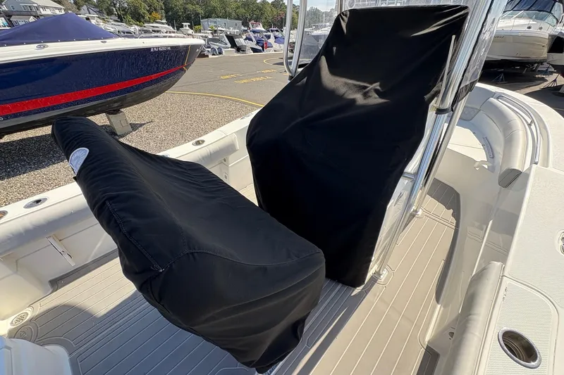Slide: The Image of 2012 Sea Fox 226 Center Console boat with covered seats in a marina setting. - 4