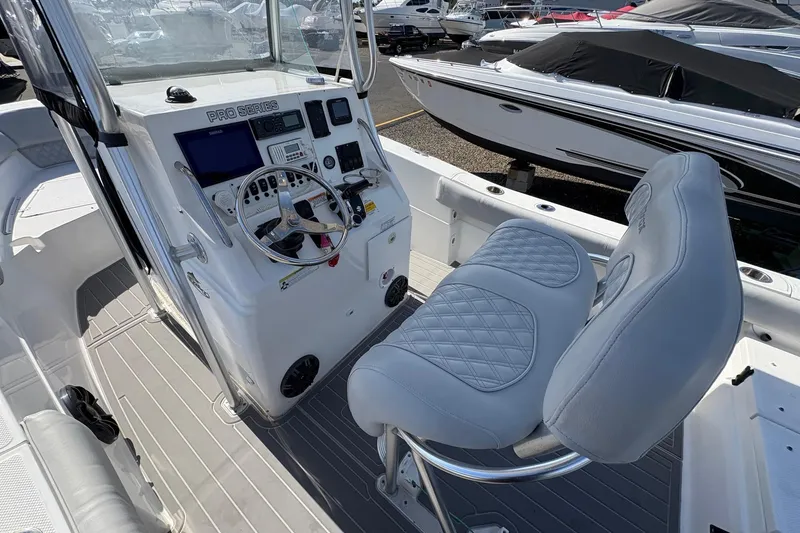Slide: The Image of 2012 Sea Fox 226 Center Console boat interior with steering wheel and seating. - 5