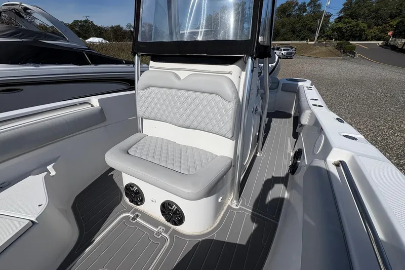 Slide: The Image of 2012 Sea Fox 226 Center Console boat interior with cushioned seating and speakers. - 7
