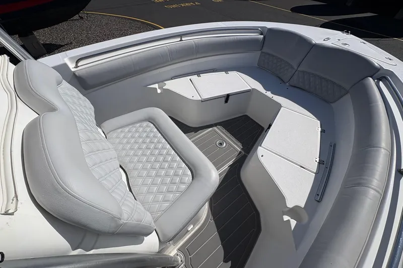 Slide: The Image of 2012 Sea Fox 226 Center Console boat interior with cushioned seating and storage compartments. - 8