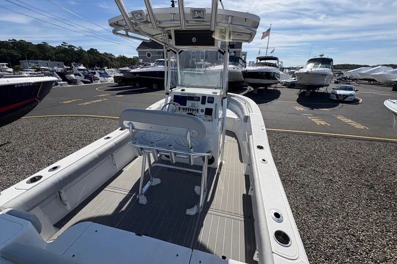 Slide: The Image of 2012 Sea Fox 226 Center Console boat in a marina, surrounded by other vessels. - 9