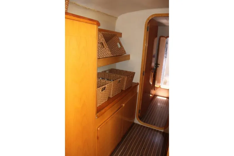 Slide: The Image of Interior of 2006 Alliaura Marine Privilege 435 EZC with wooden shelves and wicker baskets. - 13