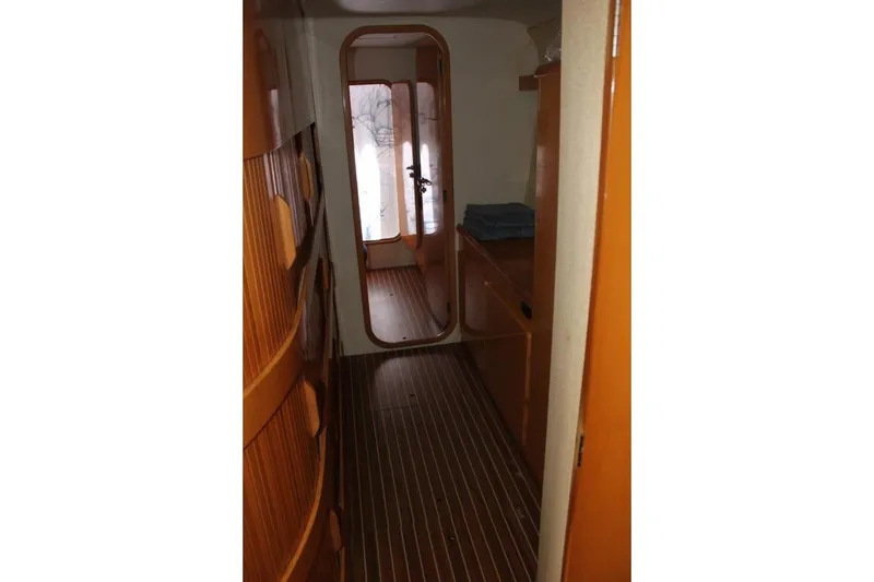 Slide: The Image of 2006 Alliaura Marine Privilege 435 EZC interior hallway with wood paneling and striped flooring. - 16