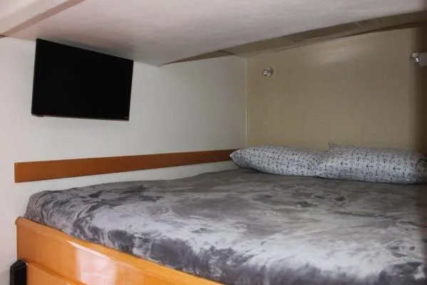 Slide: The Image of Cozy cabin interior of 2006 Alliaura Marine Privilege 435 EZC with bed and wall-mounted TV. - 17