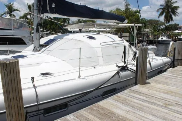 Slide: The Image of 2006 Alliaura Marine Privilege 435 EZC catamaran docked at a marina. - 2