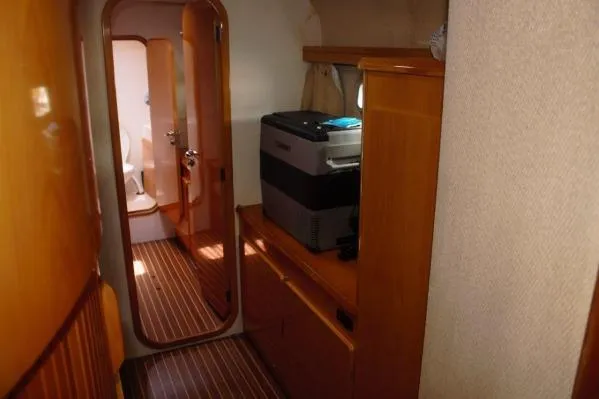 Slide: The Image of Interior of 2006 Alliaura Marine Privilege 435 EZC yacht, featuring wood paneling and compact appliances. - 21