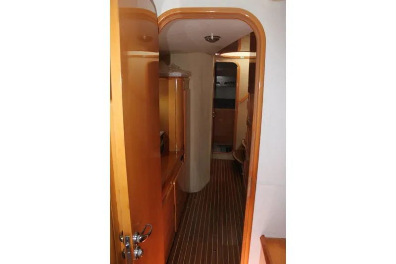 Slide: The Image of Interior hallway of 2006 Alliaura Marine Privilege 435 EZC yacht, featuring wooden finishes. - 28