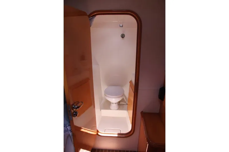 Slide: The Image of 2006 Alliaura Marine Privilege 435 EZC yacht bathroom interior with wooden door and toilet. - 29