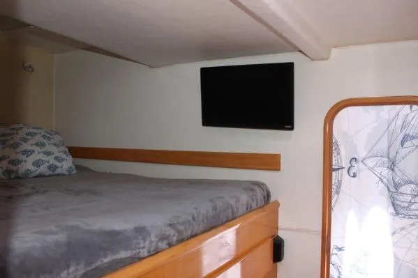 Slide: The Image of 2006 Alliaura Marine Privilege 435 EZC cabin with bed, TV, and nautical decor. - 31