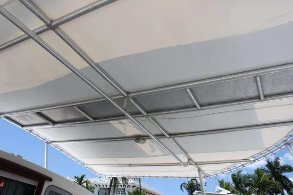 Slide: The Image of Canopy of 2006 Alliaura Marine Privilege 435 EZC catamaran, featuring metal frame and fabric cover. - 36