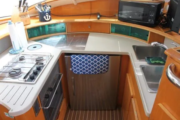 Slide: The Image of 2006 Alliaura Marine Privilege 435 EZC yacht kitchen with stove, sink, and microwave. - 4
