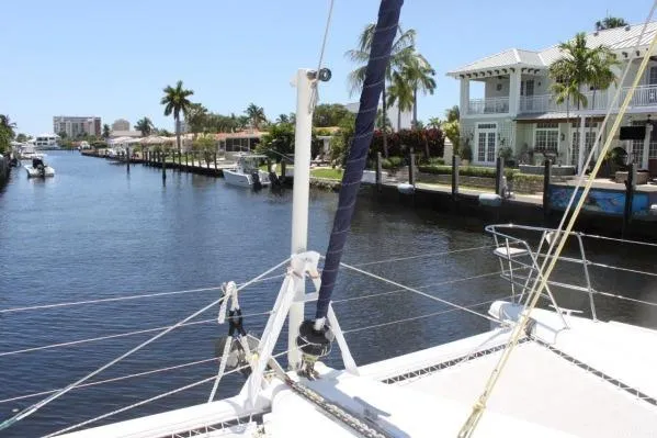 Slide: The Image of 2006 Alliaura Marine Privilege 435 EZC catamaran docked in a scenic canal setting. - 43