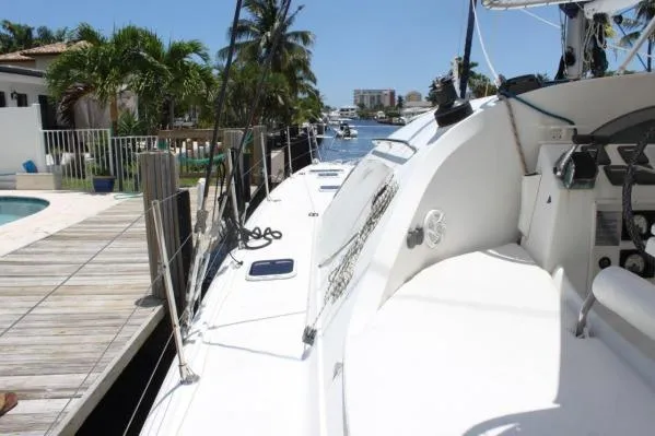 Slide: The Image of 2006 Alliaura Marine Privilege 435 EZC catamaran docked by a tropical waterfront. - 49