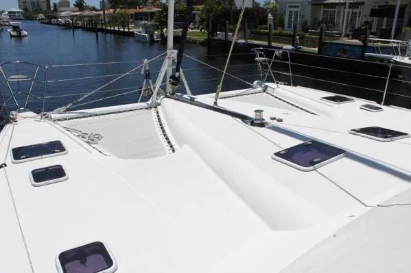 Slide: The Image of 2006 Alliaura Marine Privilege 435 EZC catamaran deck view, docked in a serene marina. - 50