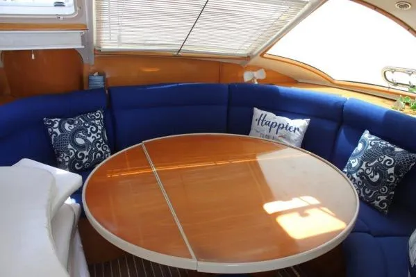 Slide: The Image of Luxurious 2006 Alliaura Marine Privilege 435 EZC yacht interior with blue seating and round table. - 7