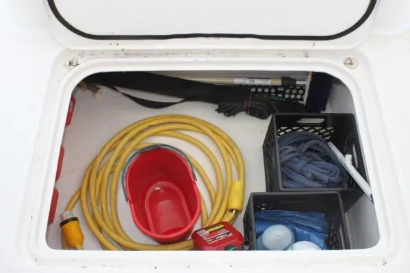 Slide: The Image of Storage compartment of 2006 Alliaura Marine Privilege 435 EZC with cables, bucket, and supplies. - 76