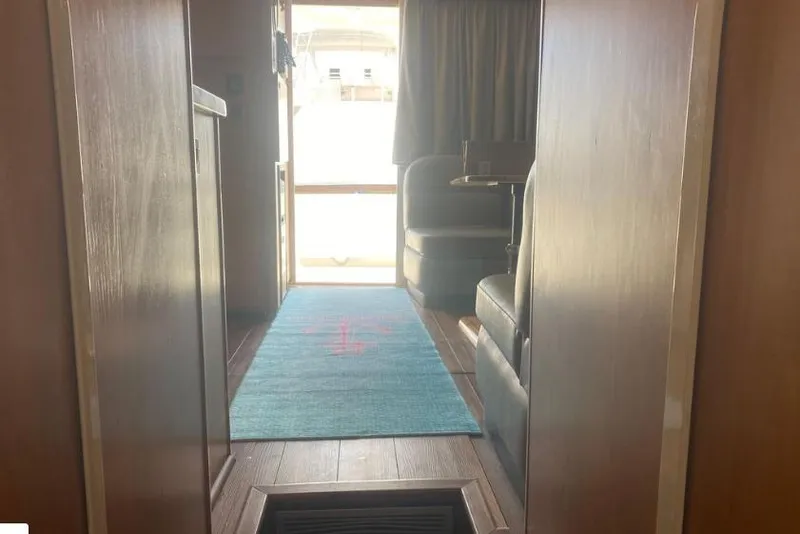 Slide: The Image of Interior view of 2000 Luhrs Tournament 360 Convertible yacht, featuring seating and a blue rug. - 11