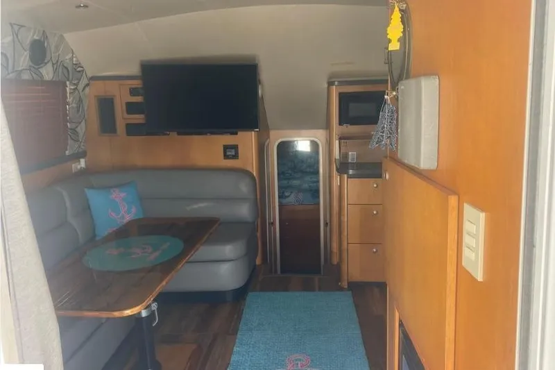 Slide: The Image of Interior of 2000 Luhrs Tournament 360 Convertible with seating, table, and TV. - 14