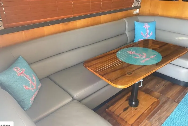Slide: The Image of Interior of 2000 Luhrs Tournament 360 Convertible with cozy seating and nautical decor. - 16