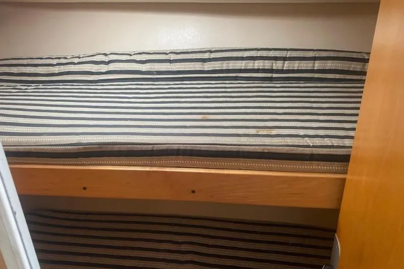 Slide: The Image of Bunk beds with striped mattresses in 2000 Luhrs Tournament 360 Convertible boat cabin. - 20