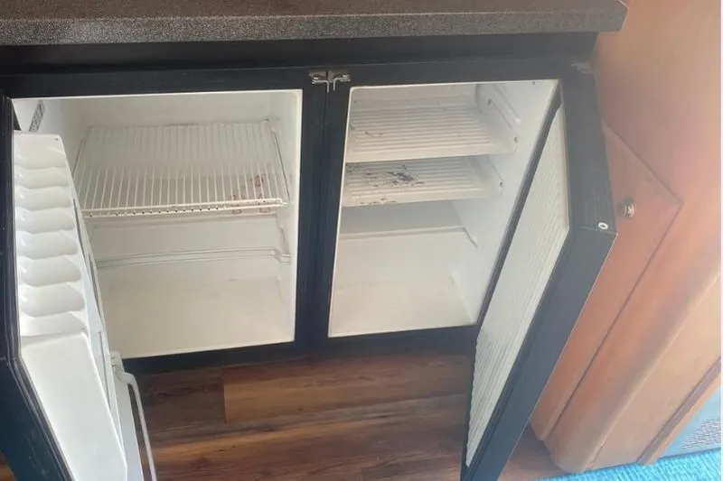 Slide: The Image of Open refrigerator in 2000 Luhrs Tournament 360 Convertible boat interior. - 23